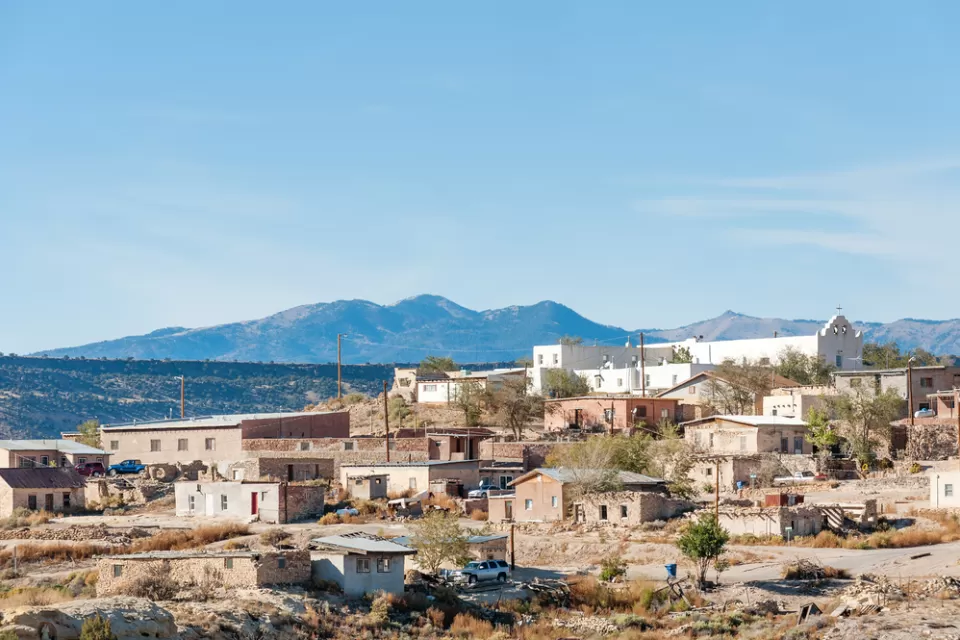 The Laguna Pueblo, a Native American reservation near Albuquerque, New Mexico, is perched on a hill in the sun.
